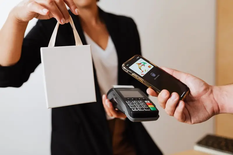 Person paying cashless with a mobile phone